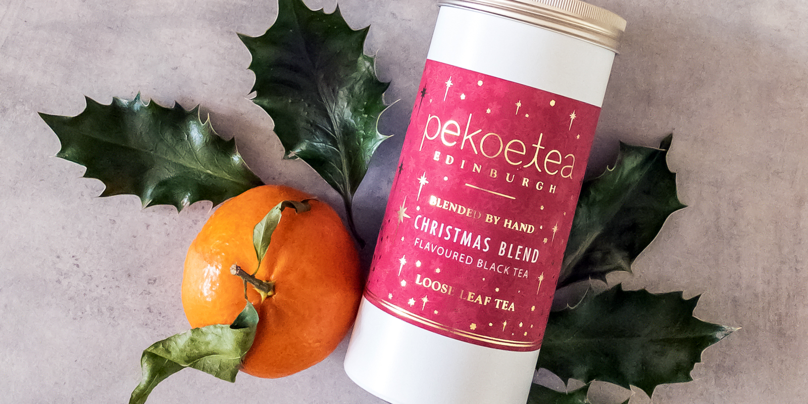 A Christmas Tea caddy with a clementine and some greenery