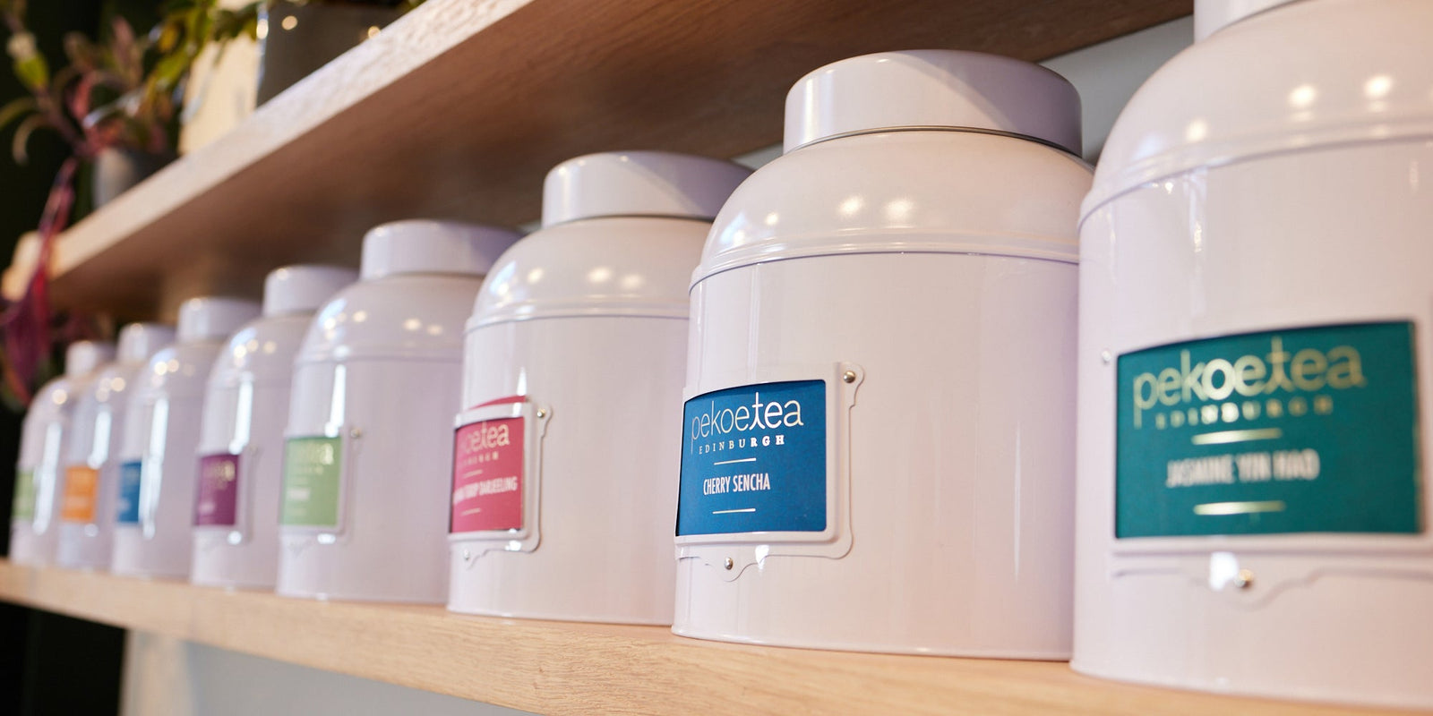 a line of big tins full of tea available for refilling