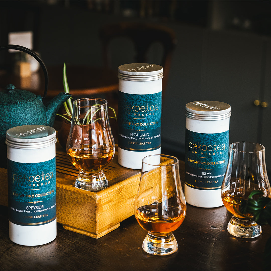 Trio of PekoeTea Edinburgh Whisky Tea Caddies with Teas in Glen Cairn Glasses and Green cast iron teapot in the background